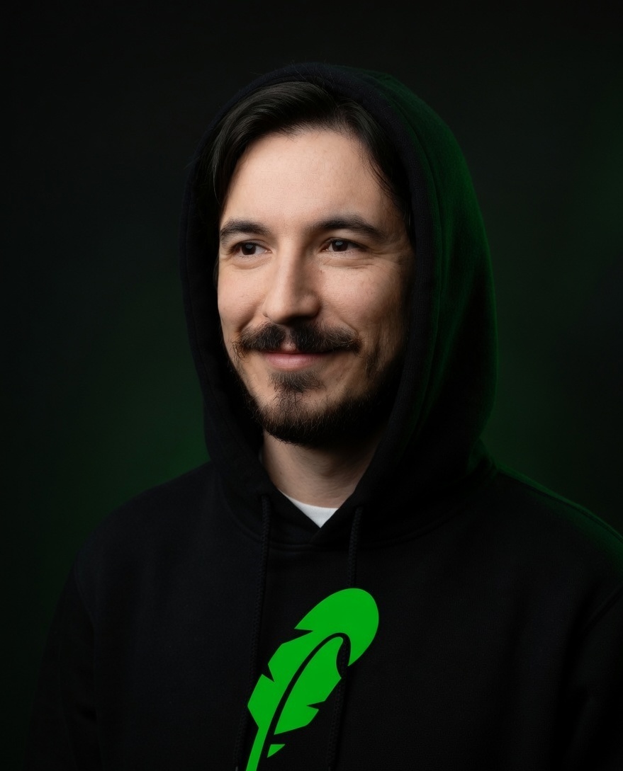 Vlad in a black hood with green light
